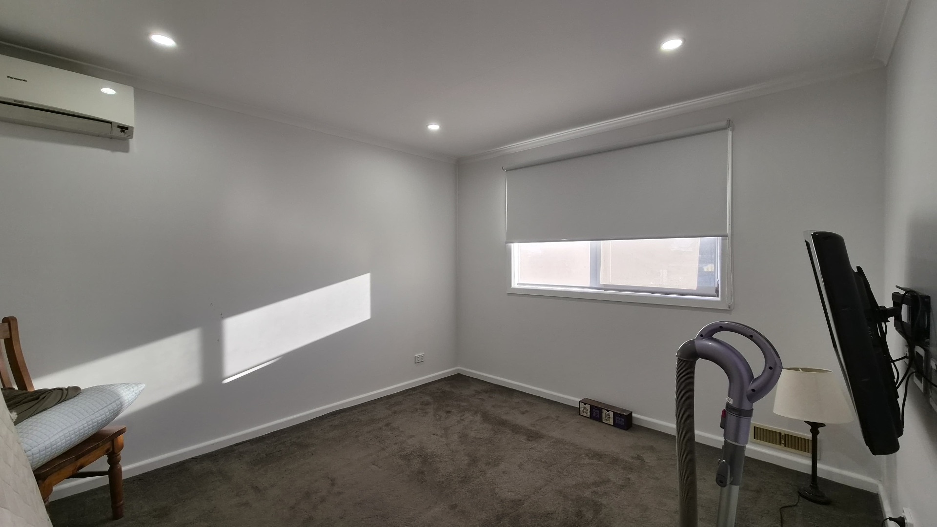 Upstairs bedroom with split system and carpet